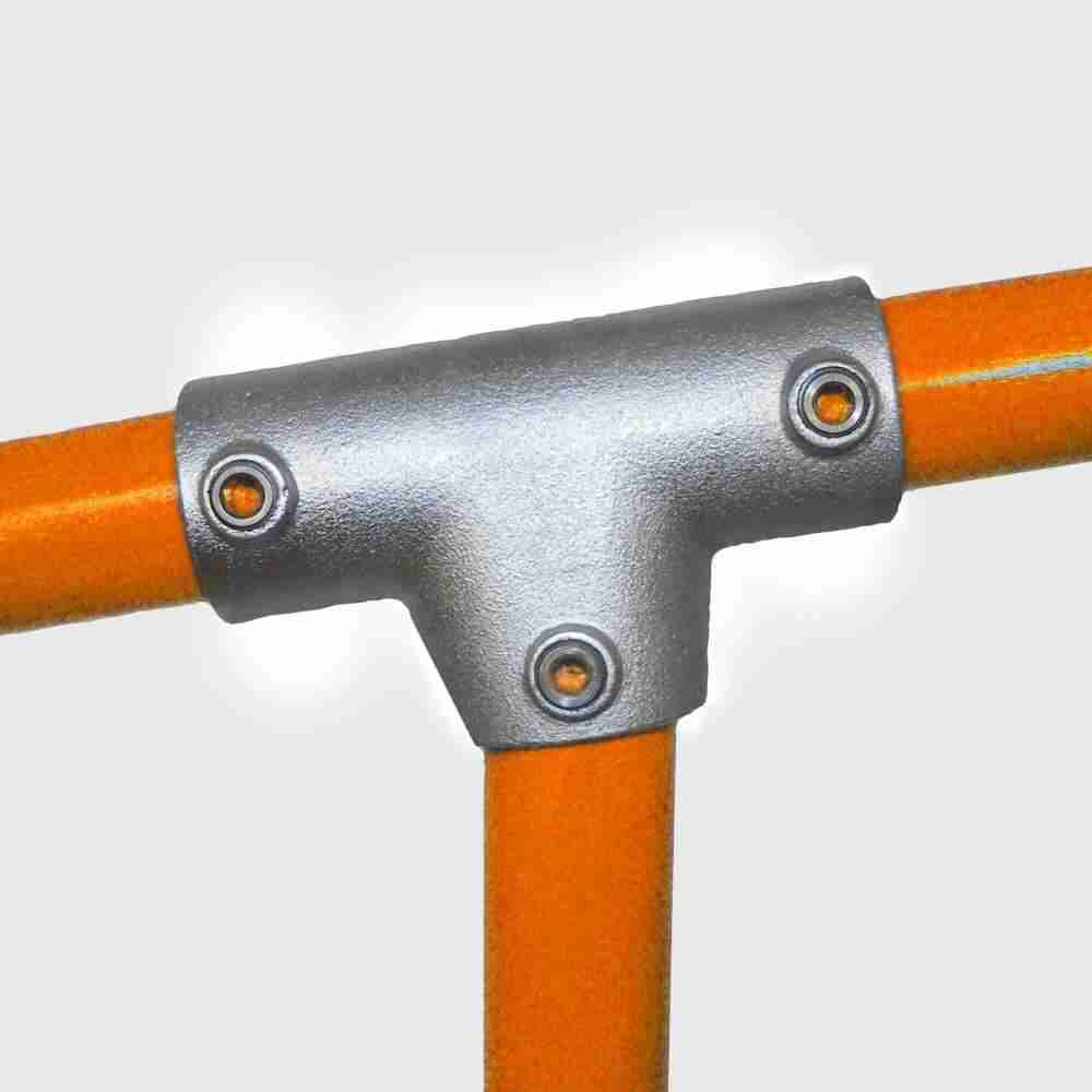 Close-up of a metallic handlebar junction with orange bars on a white background