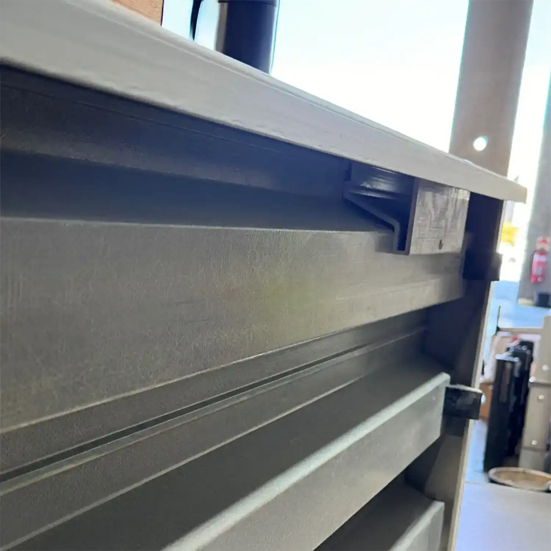 Metal shelving unit with a white top shelf in an indoor setting